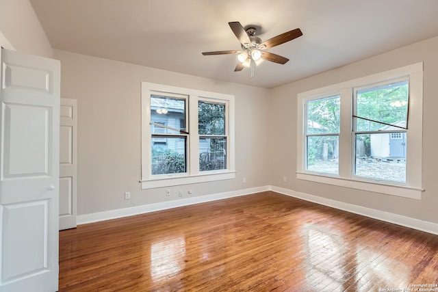 spare room with hardwood / wood-style flooring and ceiling fan