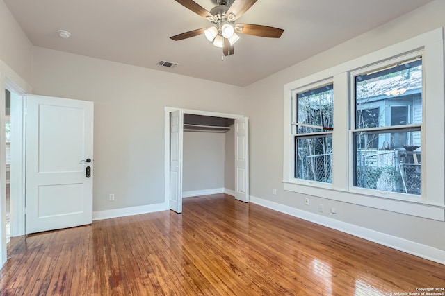 unfurnished bedroom with a closet, ceiling fan, and hardwood / wood-style floors