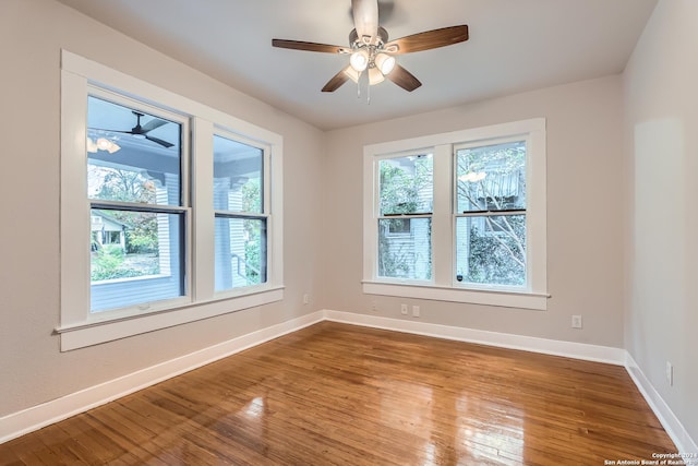 unfurnished room with hardwood / wood-style flooring, ceiling fan, and a wealth of natural light