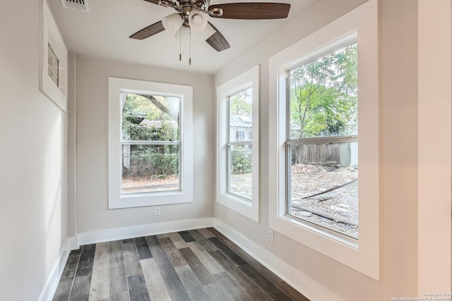 spare room with ceiling fan, dark hardwood / wood-style flooring, and a wealth of natural light