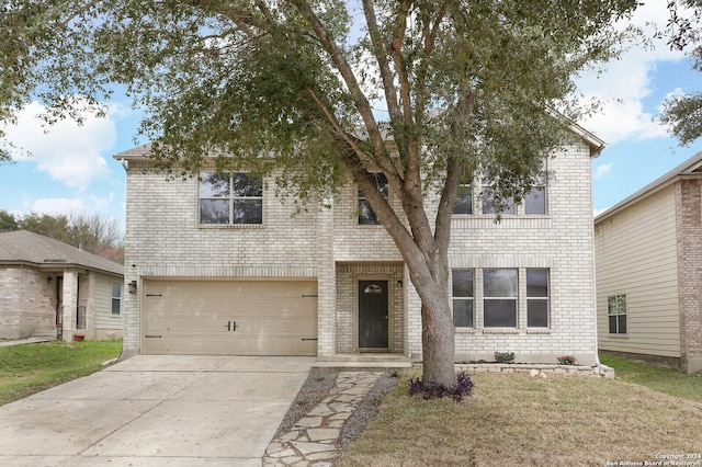 front facade featuring a front yard and a garage