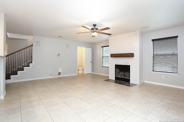 unfurnished living room with ceiling fan and light tile patterned floors