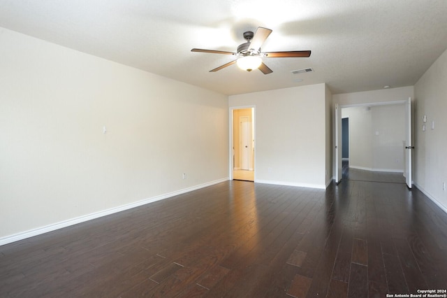 empty room featuring a textured ceiling, dark hardwood / wood-style flooring, and ceiling fan