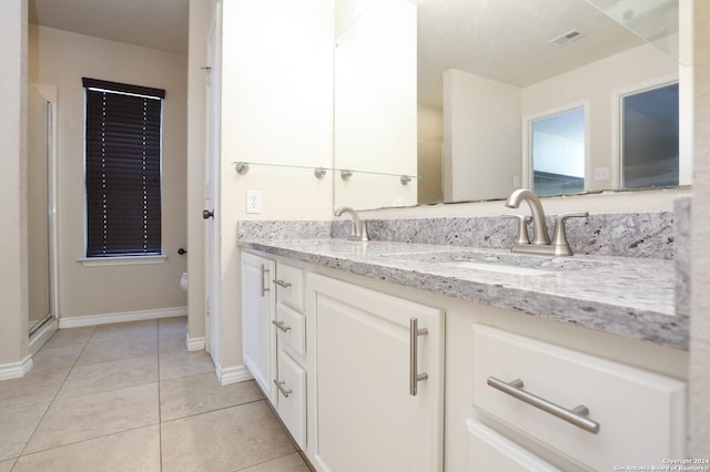 bathroom with tile patterned flooring, vanity, and toilet