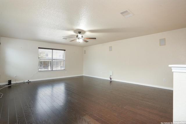 unfurnished room with a textured ceiling, ceiling fan, and dark wood-type flooring