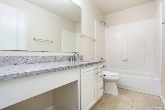 full bathroom featuring tiled shower / bath, tile patterned flooring, vanity, and toilet