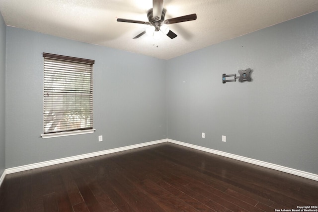 spare room featuring ceiling fan and dark wood-type flooring