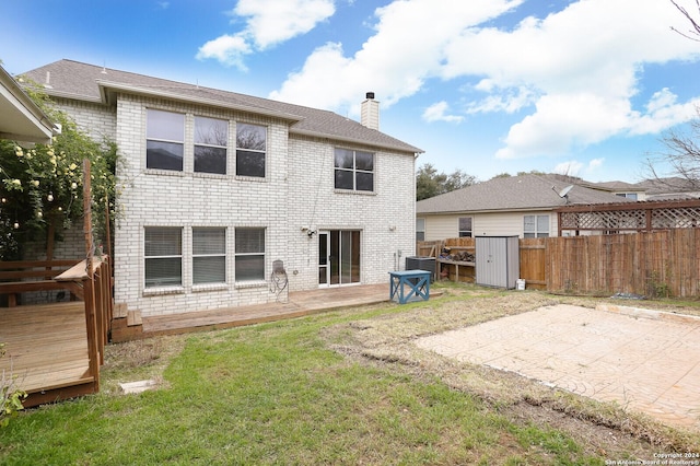 back of property with a patio, central AC, a deck, and a lawn