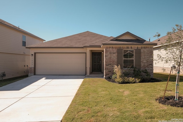 ranch-style house featuring a garage and a front yard