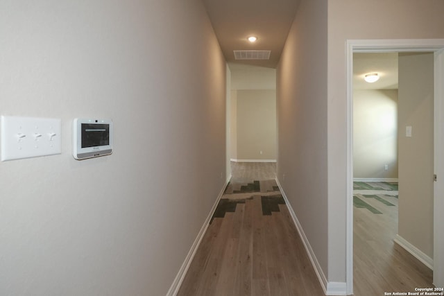 hallway with hardwood / wood-style flooring