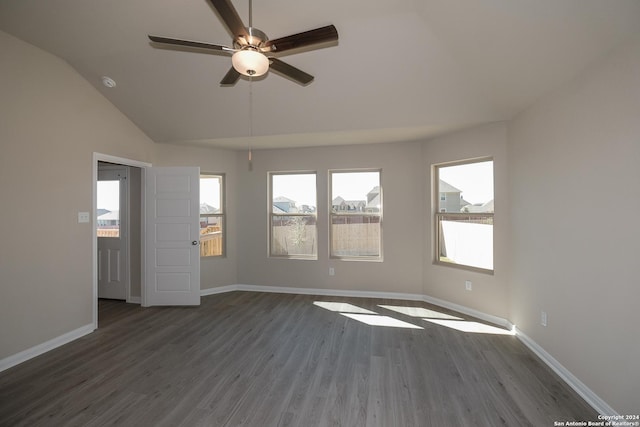 spare room with dark wood-type flooring, ceiling fan, and lofted ceiling