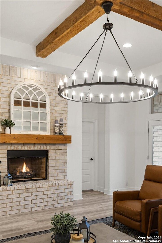 living room featuring a fireplace, wood-type flooring, and vaulted ceiling with beams