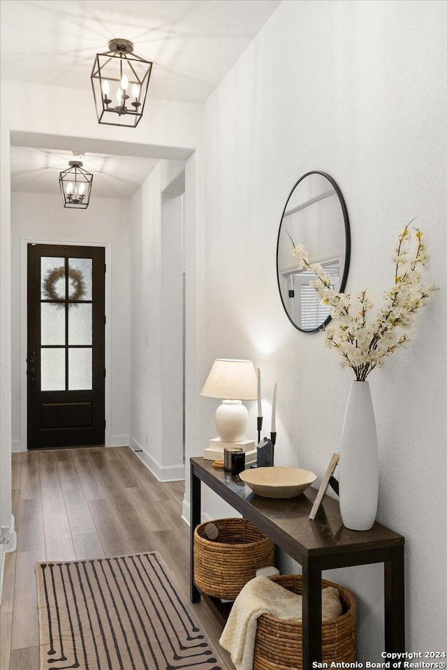 entrance foyer featuring an inviting chandelier and hardwood / wood-style flooring