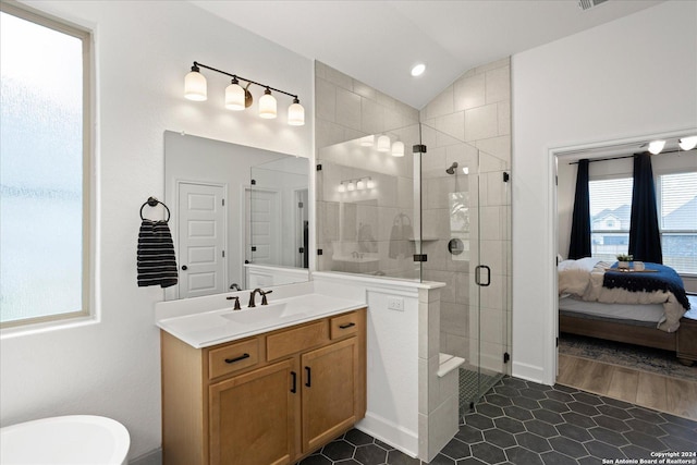 bathroom featuring vanity, wood-type flooring, walk in shower, and vaulted ceiling