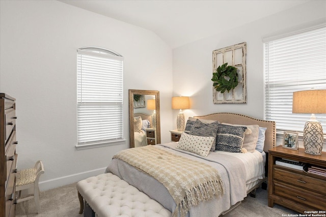 carpeted bedroom with lofted ceiling