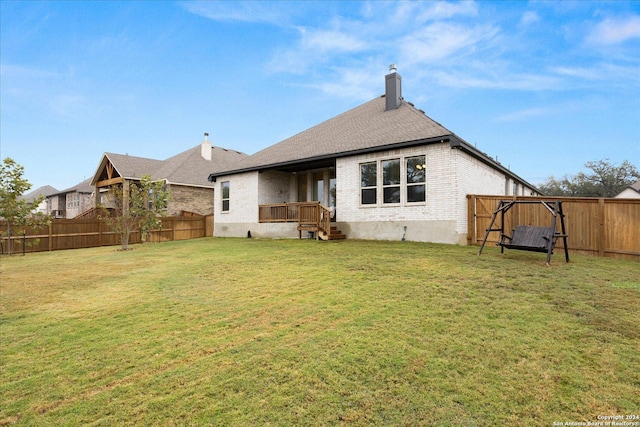 rear view of property featuring a yard