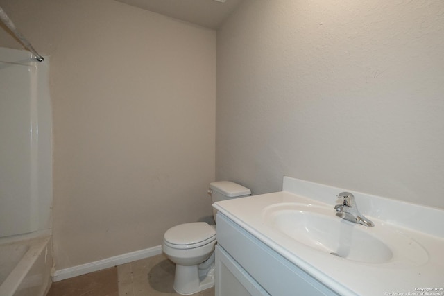 bathroom featuring vanity, tile patterned floors, and toilet