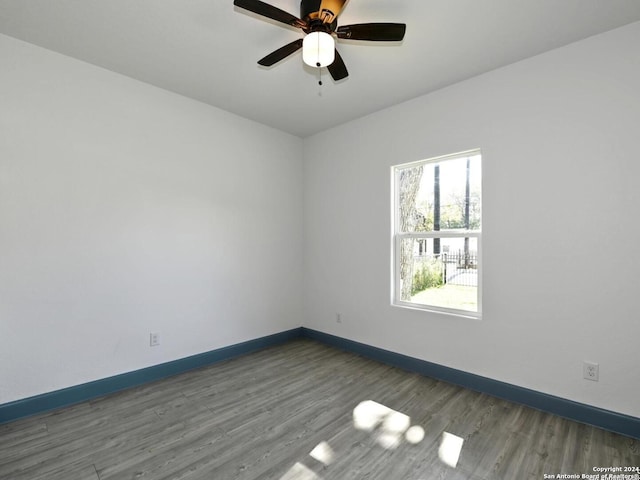 empty room featuring dark hardwood / wood-style floors and ceiling fan