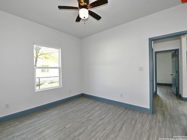 empty room with light hardwood / wood-style floors and ceiling fan