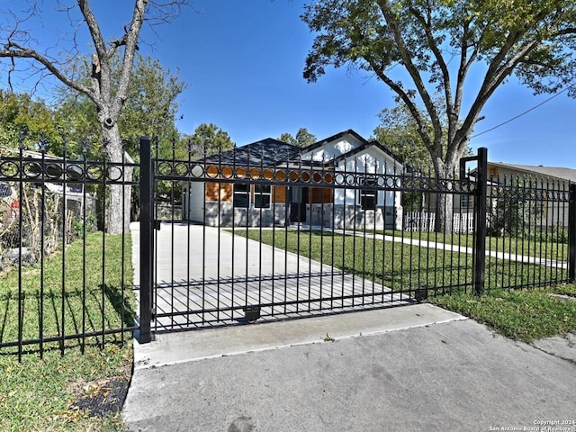 view of gate with a yard