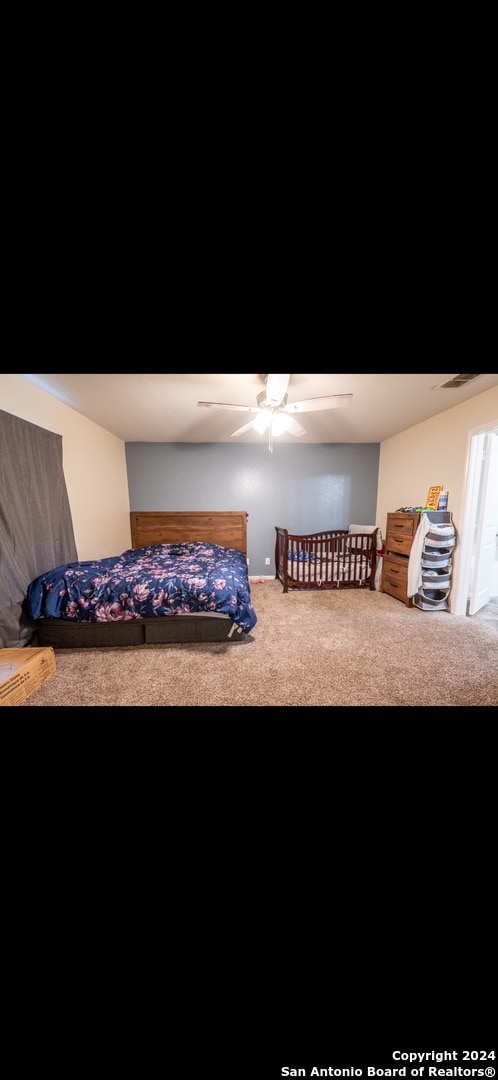 carpeted bedroom with ceiling fan