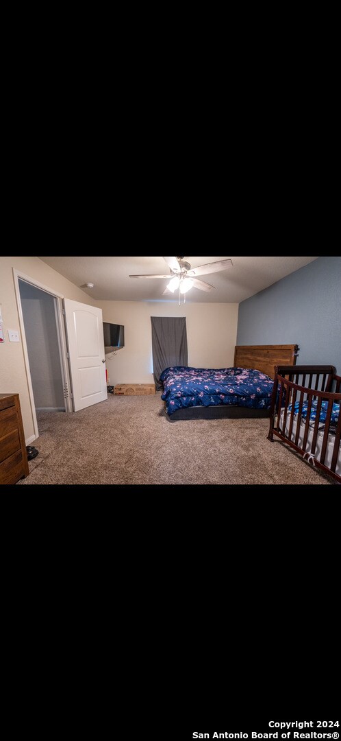 carpeted bedroom featuring ceiling fan