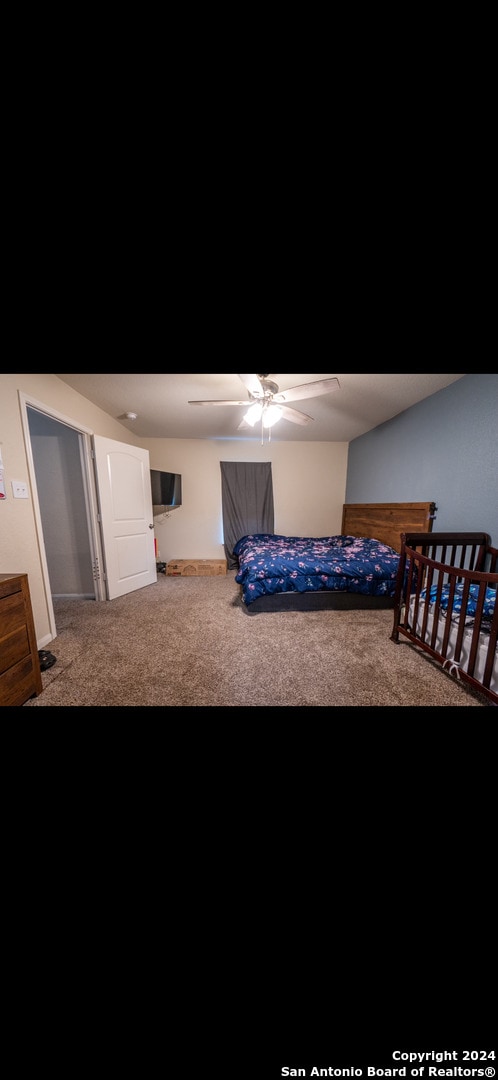 bedroom featuring ceiling fan and carpet floors