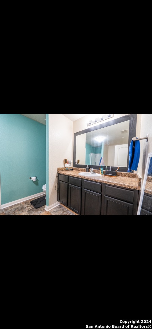 bathroom featuring vanity and toilet