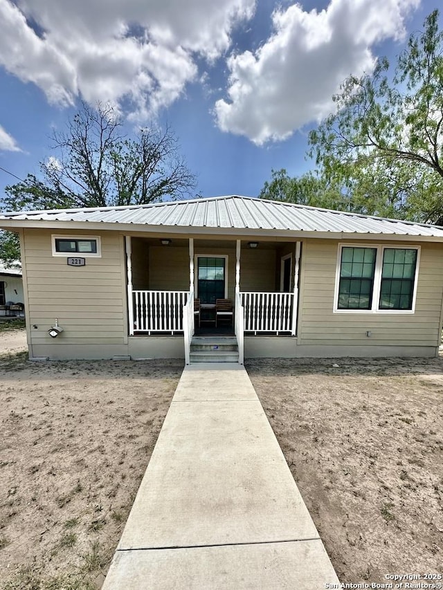 221 Chaparral St, Uvalde, TX 78801 - ranch-style house with covered porch and a metal roof