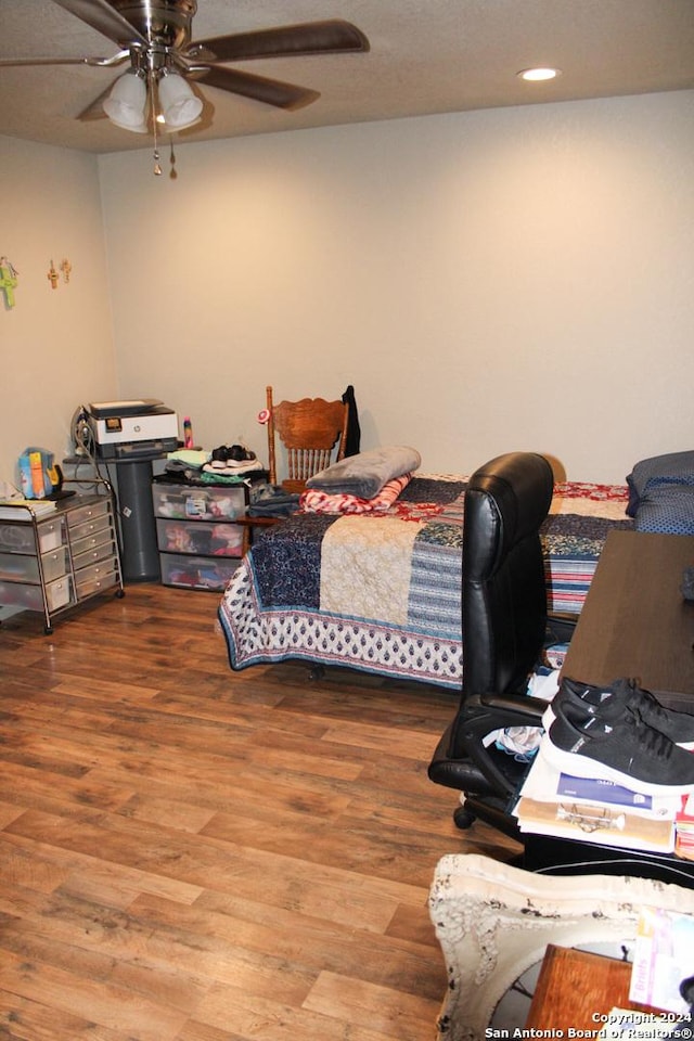 bedroom featuring hardwood / wood-style flooring and ceiling fan