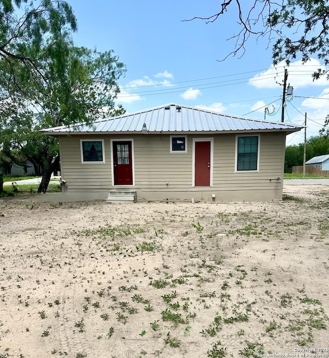 221 Chaparral St, Uvalde, TX 78801 - ranch-style home featuring entry steps and a metal roof
