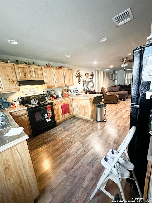 kitchen featuring light brown cabinets, sink, electric range, ceiling fan, and light wood-type flooring