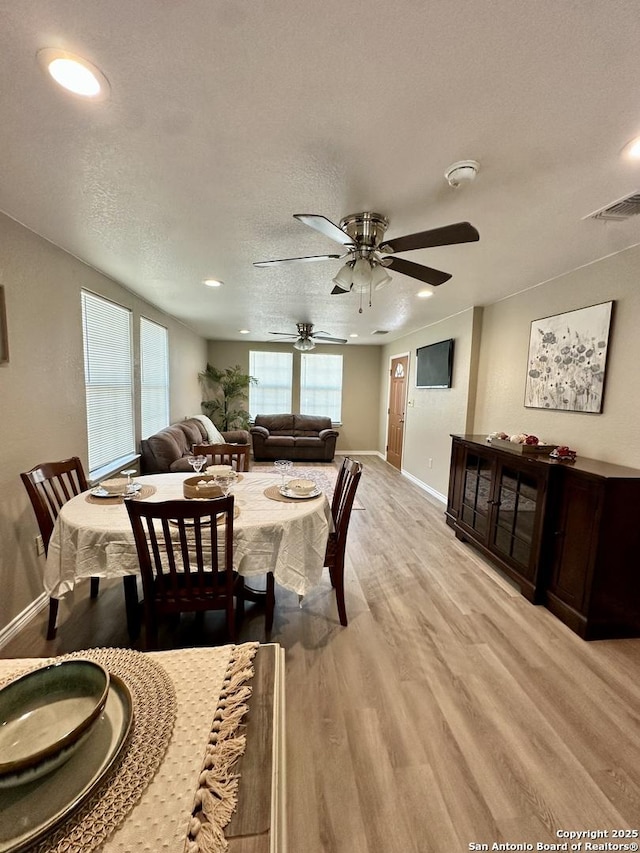 221 Chaparral St, Uvalde, TX 78801 - dining area featuring light wood-style flooring, a ceiling fan, recessed lighting, and a textured ceiling