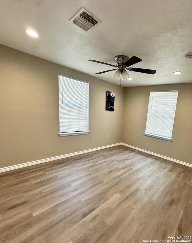 221 Chaparral St, Uvalde, TX 78801 - unfurnished room featuring ceiling fan, wood finished floors, a textured ceiling, and recessed lighting