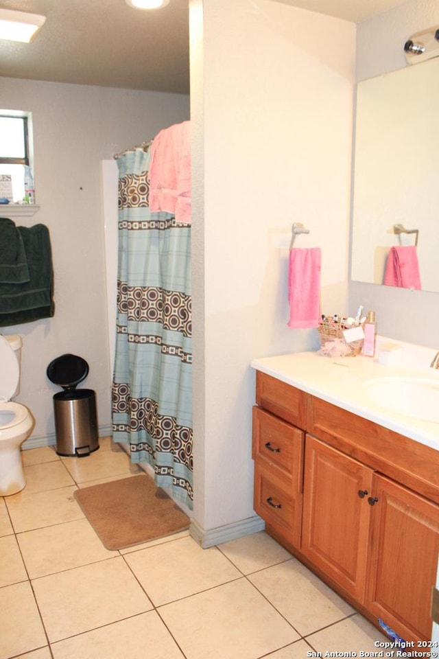 bathroom featuring tile patterned flooring, vanity, and toilet