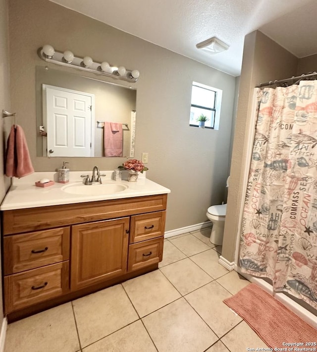 221 Chaparral St, Uvalde, TX 78801 - full bath with vanity, tile patterned flooring, a shower with shower curtain, and a textured ceiling