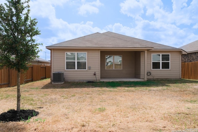 back of house with a yard, central AC, and a patio area