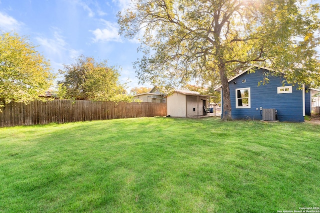 view of yard with a storage shed and central air condition unit