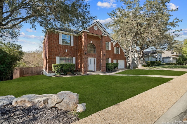 view of front of home featuring a front lawn and a garage