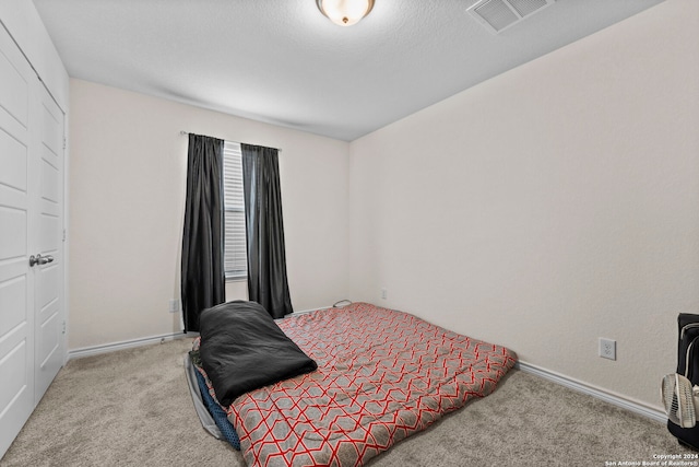 bedroom featuring light carpet