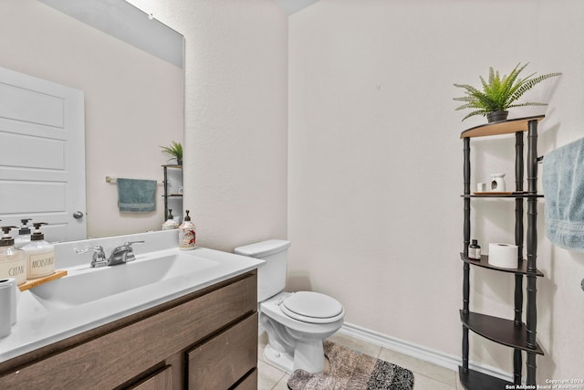 bathroom featuring toilet, vanity, and tile patterned floors