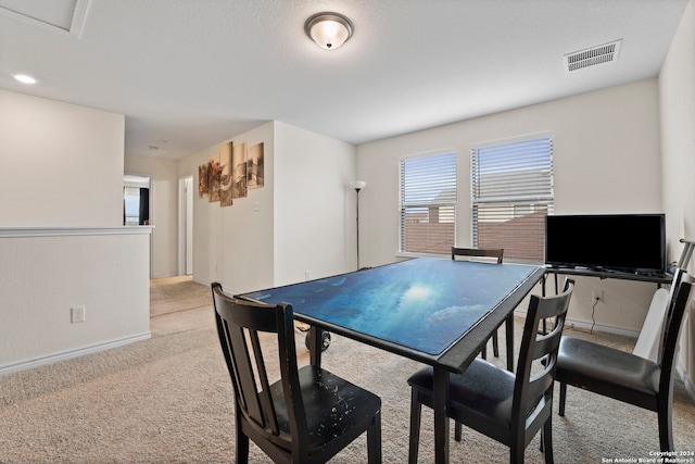 dining space with light carpet