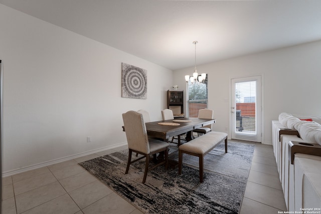 tiled dining area featuring a notable chandelier