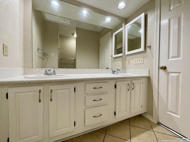 bathroom with tile patterned flooring and vanity