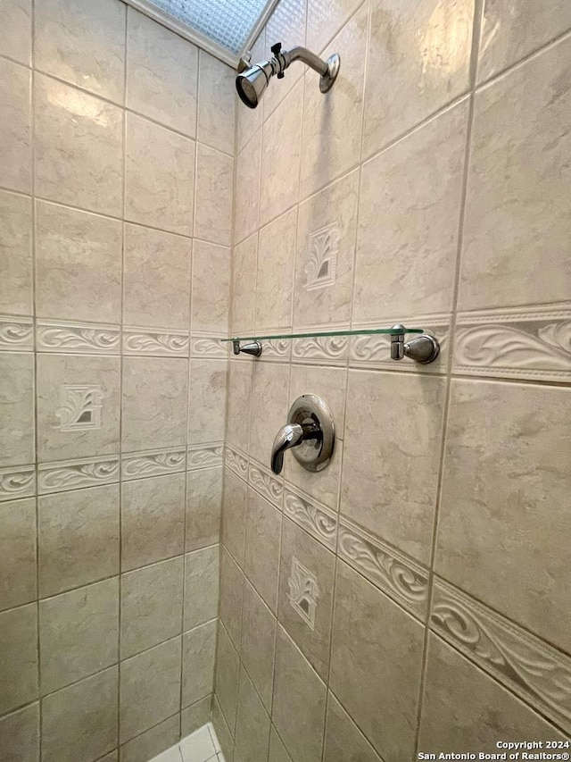 bathroom with a tile shower