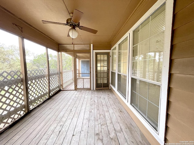 unfurnished sunroom featuring ceiling fan