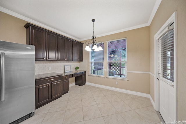 kitchen with hanging light fixtures, stainless steel fridge, decorative backsplash, light tile patterned flooring, and dark brown cabinetry