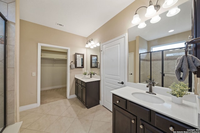 bathroom featuring an enclosed shower, vanity, tile patterned floors, and an inviting chandelier