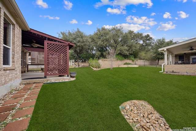 view of yard with ceiling fan