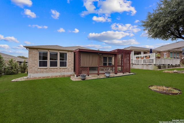 back of house with a lawn